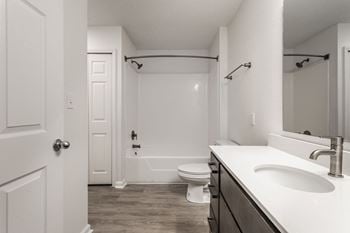 A bathroom with a sink and a toilet and a shower